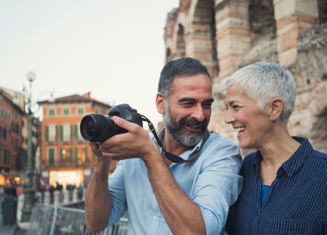 A couple in their late fifties walking together outdoors